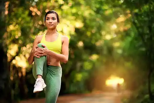 Young woman stretching to get ready before brisk walk